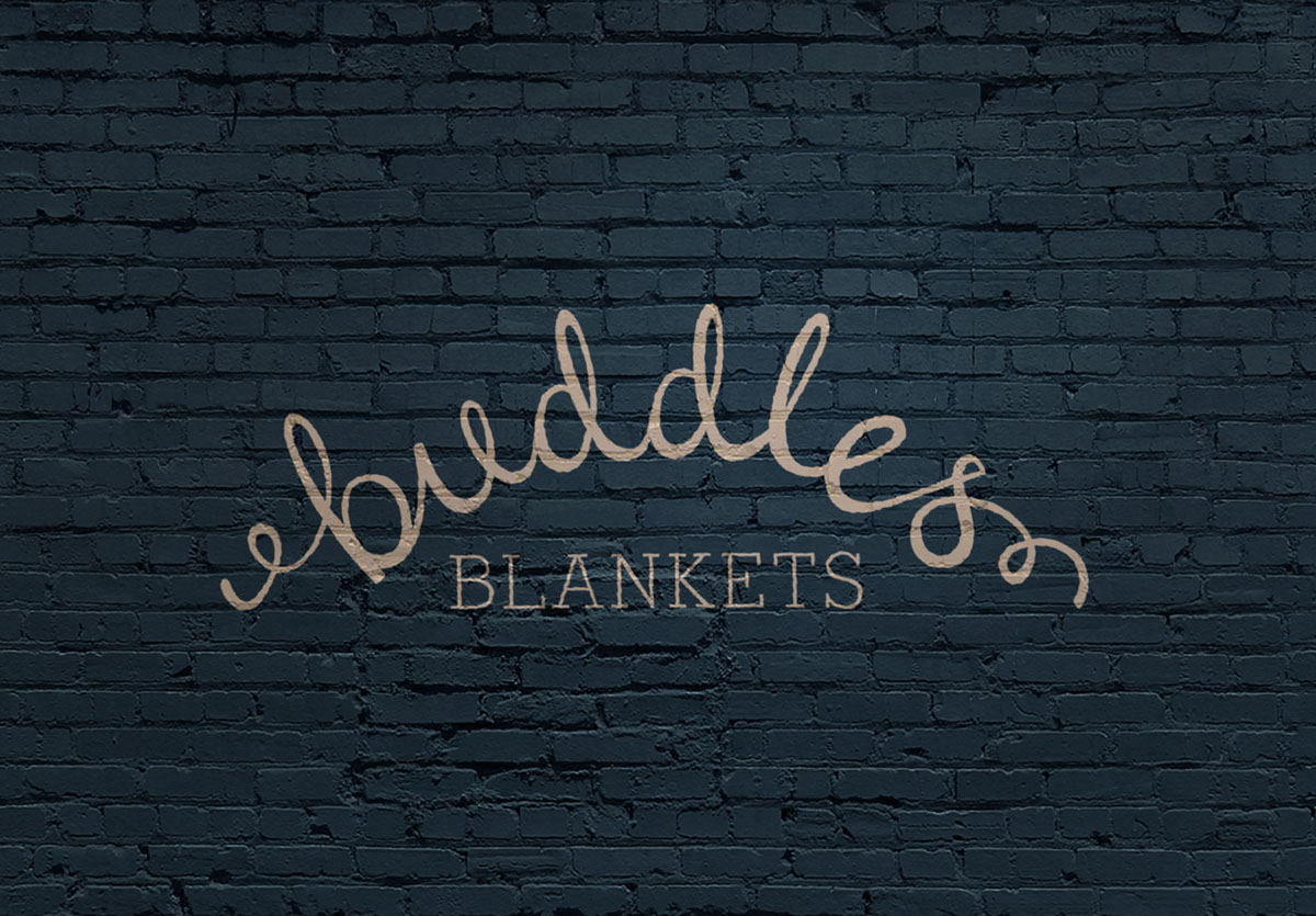 Buddles Logo Gold on a Black Brick wall